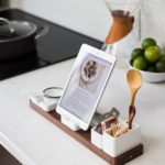 ipad resting on cunter displaying recipe along side kitchen utensils